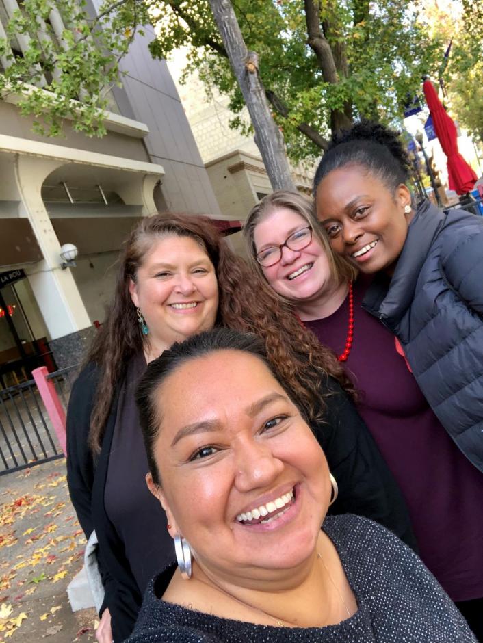 Four people pose for a selfie in Sacramento.