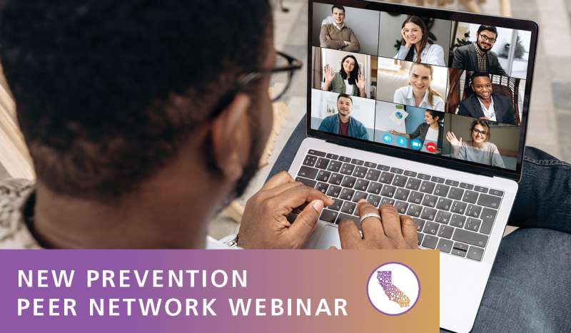 Image shows a black man sitting with a laptop on his crossed leg. Laptop has images of folks in a Zoom meeting