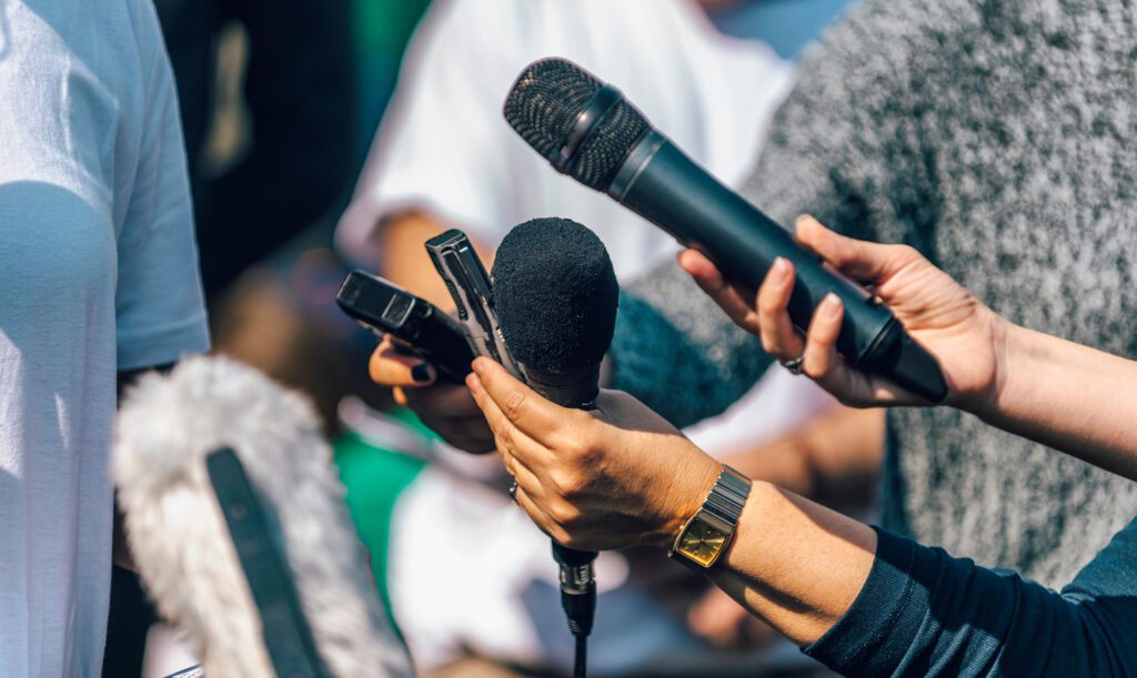 Journalists holding microphones